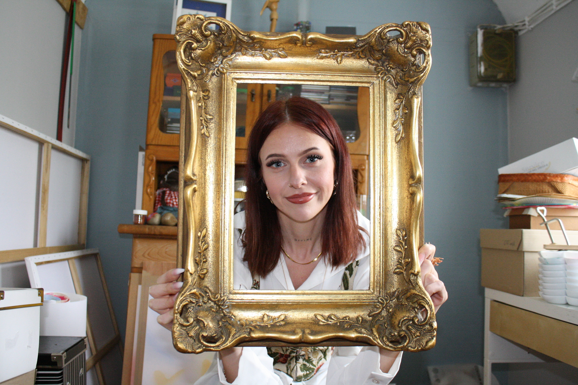 Jess sitting near a mirror in the woods.