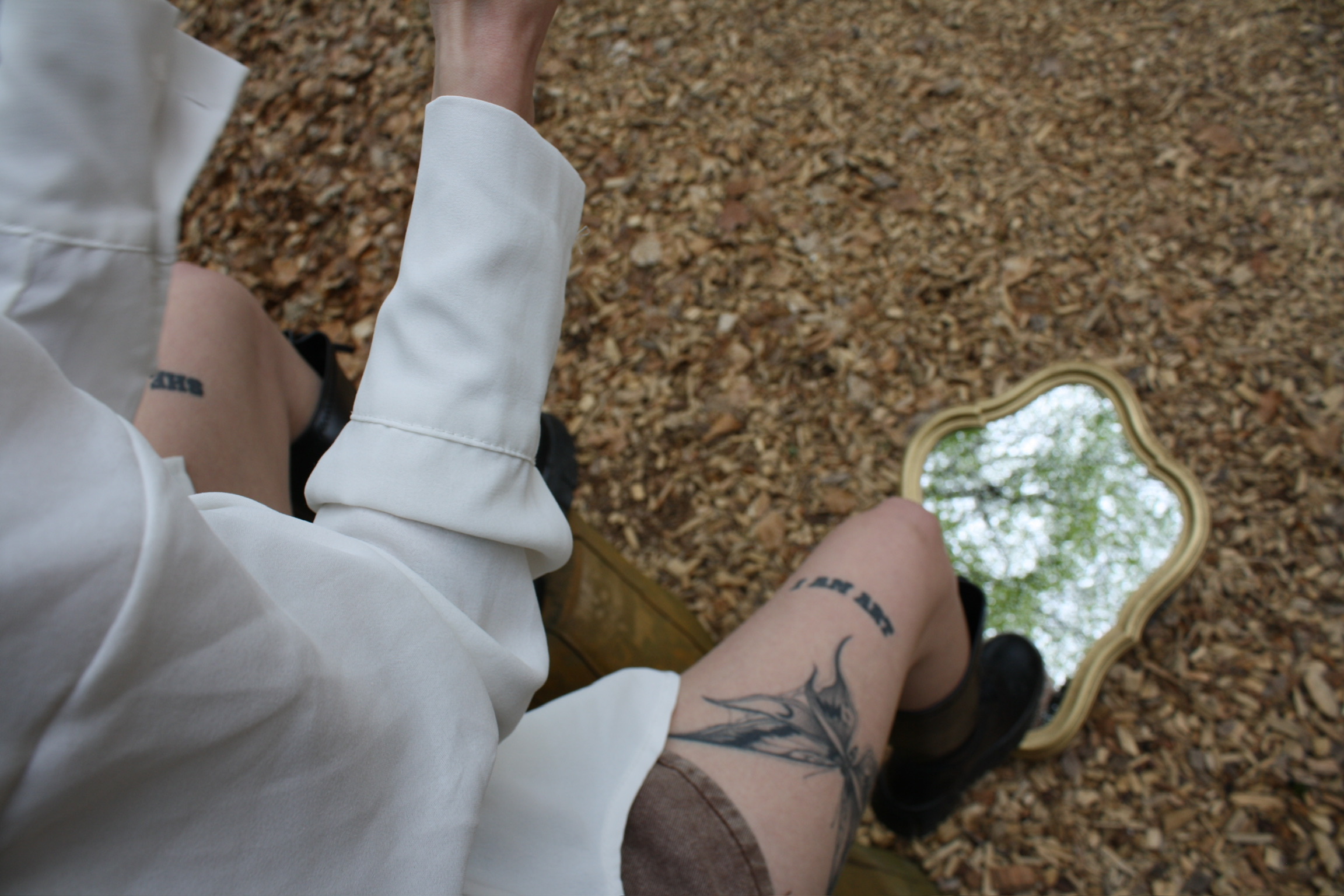 Jess reflected in a mirror in the forest.